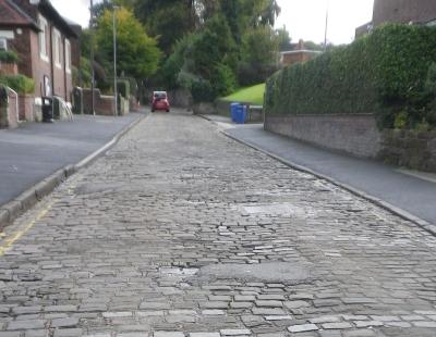Image of the historic stone setts stretching along Pepper Street in Lymm.