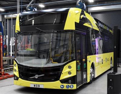 Image of a yellow electric bus parked at the Warrington Own buses depot.