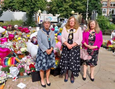 The Mayor of Warrington standing with her consort and the Mayor of Sefton after laying flowers in tribute to the victims of the Southport attack