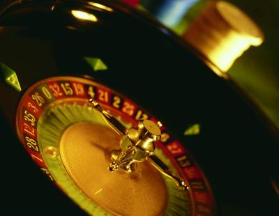 Image of a roulette table in a casino.