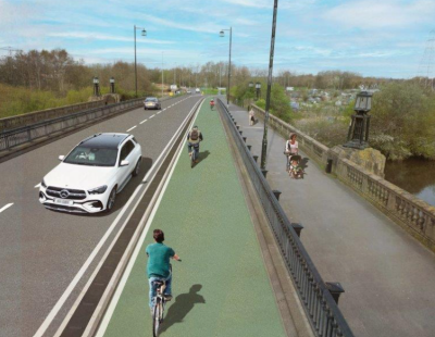 Artist's impression of the Kingsway Bridge Improvement Scheme, showing two cyclists cycling along a cycle path, separated from a two lane highway, along which two cars are travelling in the opposite direction..